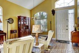 2120 Northwest Marsh Rabbit Lane Jensen Beach, FL 34957 - Photo 9 of 34 a living room with furniture and a chandelier