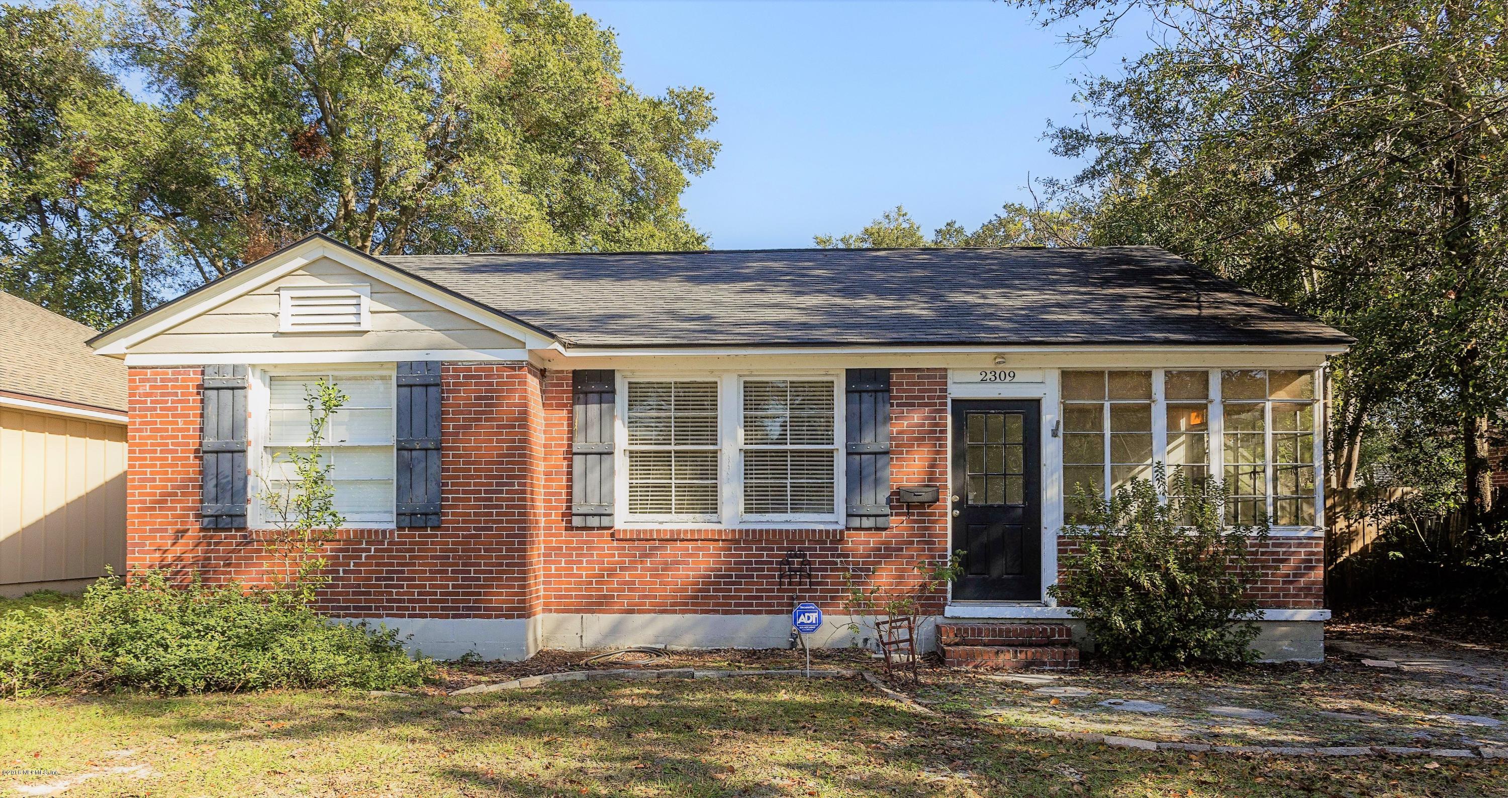 2309 Somerset Road Jacksonville, FL 32210 - Photo 1 of 21 a front view of a house with a garden