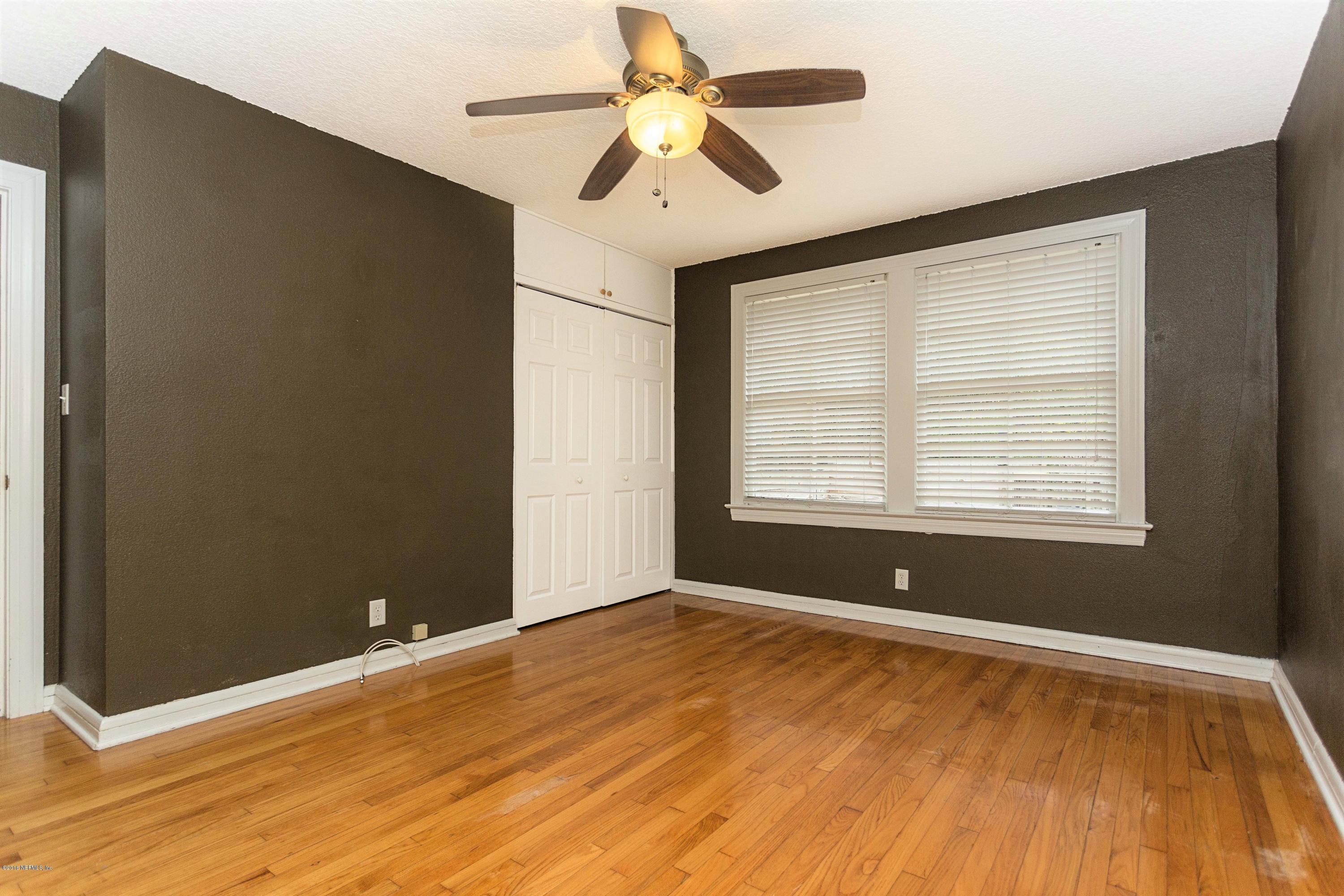 2309 Somerset Road Jacksonville, FL 32210 - Photo 11 of 21 a view of an empty room with window and wooden floor