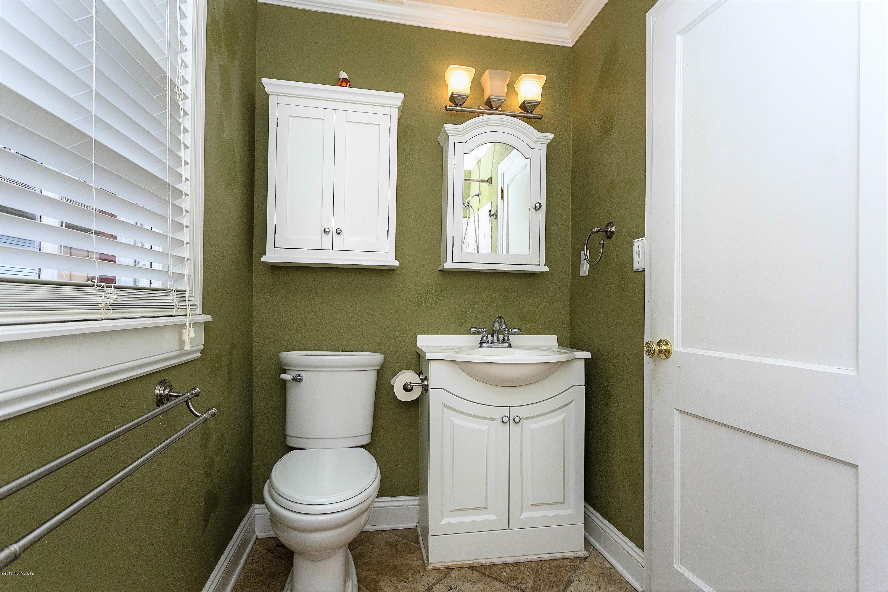 2309 Somerset Road Jacksonville, FL 32210 - Photo 12 of 21 a bathroom with a toilet sink and mirror