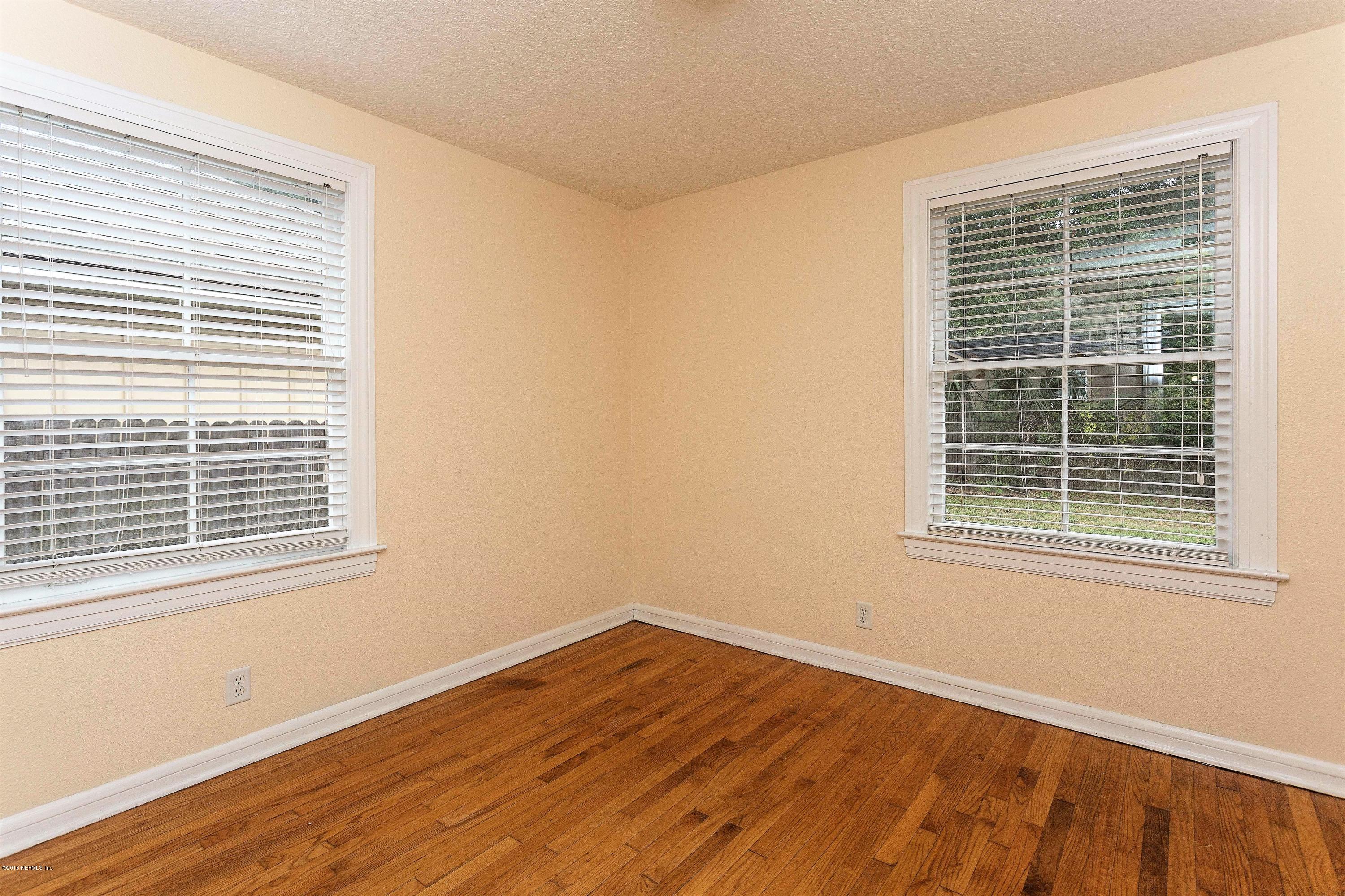 2309 Somerset Road Jacksonville, FL 32210 - Photo 15 of 21 a view of an empty room with wooden floor and a window