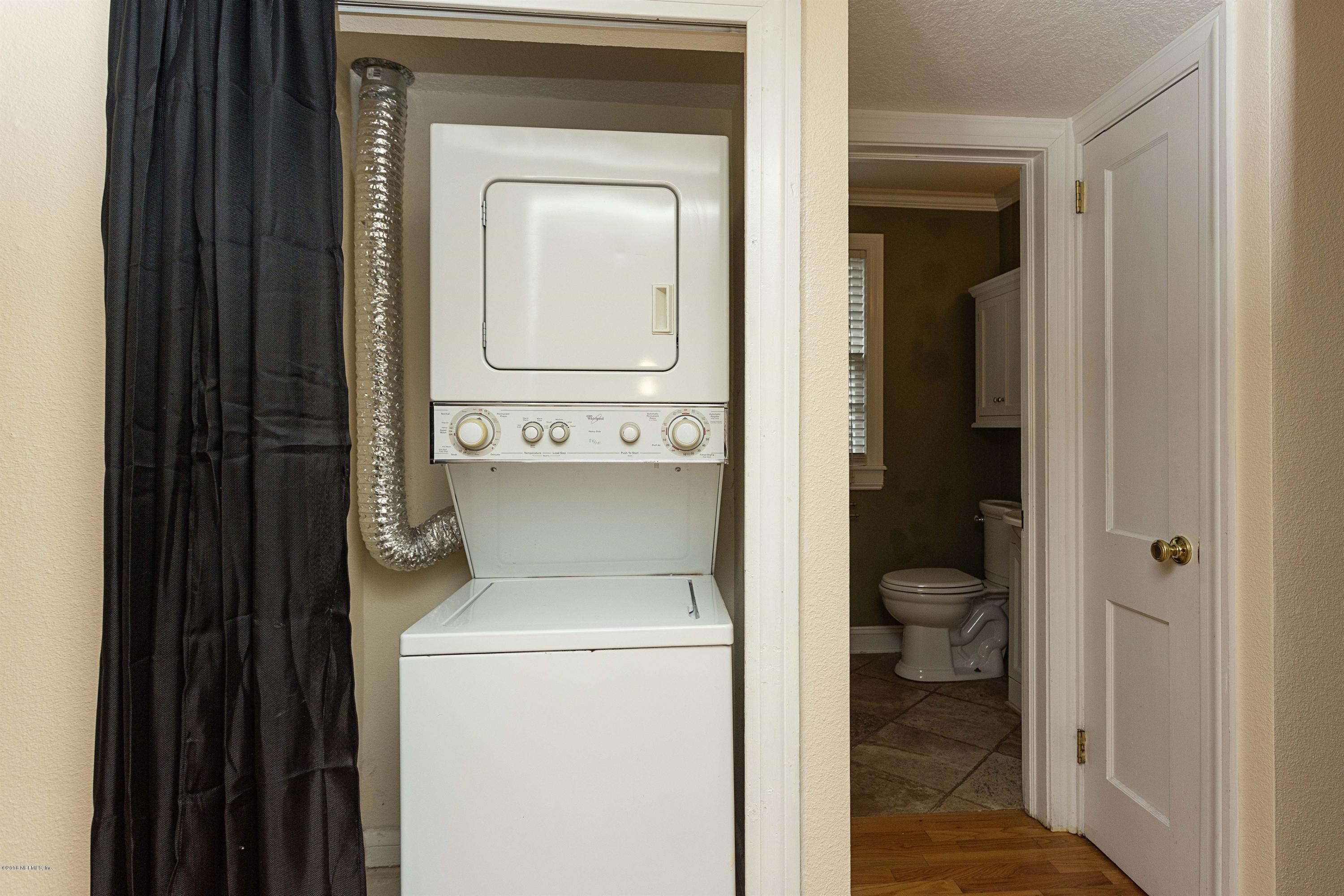 2309 Somerset Road Jacksonville, FL 32210 - Photo 16 of 21 a en suite bathroom with a toilet sink and mirror