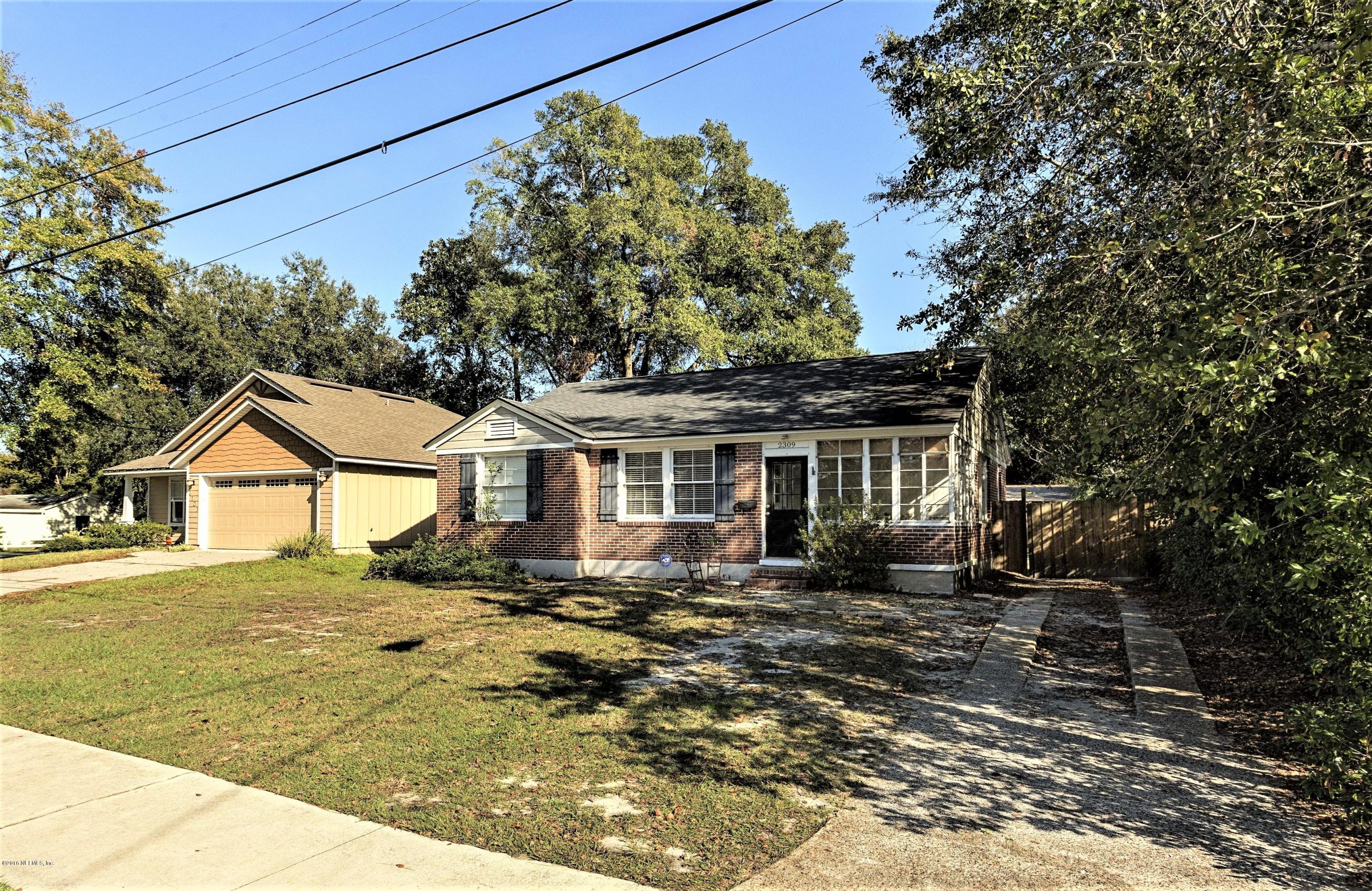 2309 Somerset Road Jacksonville, FL 32210 - Photo 19 of 21 a front view of a house with a garden