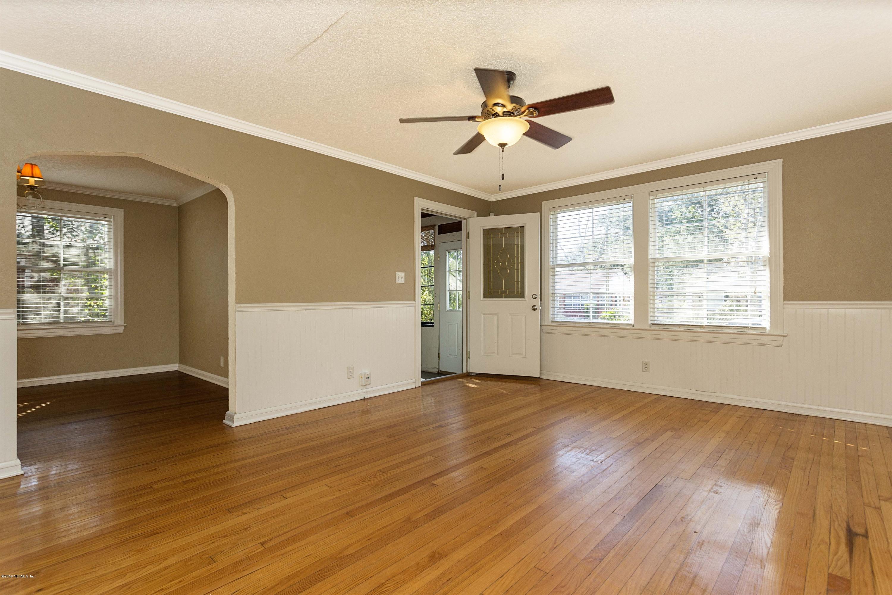 2309 Somerset Road Jacksonville, FL 32210 - Photo 4 of 21 a view of an empty room with wooden floor and a window