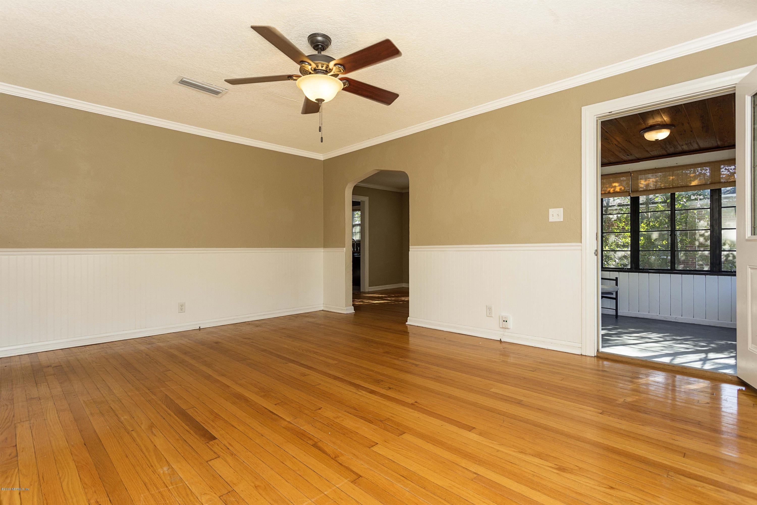 2309 Somerset Road Jacksonville, FL 32210 - Photo 6 of 21 a view of an empty room with window and wooden floor