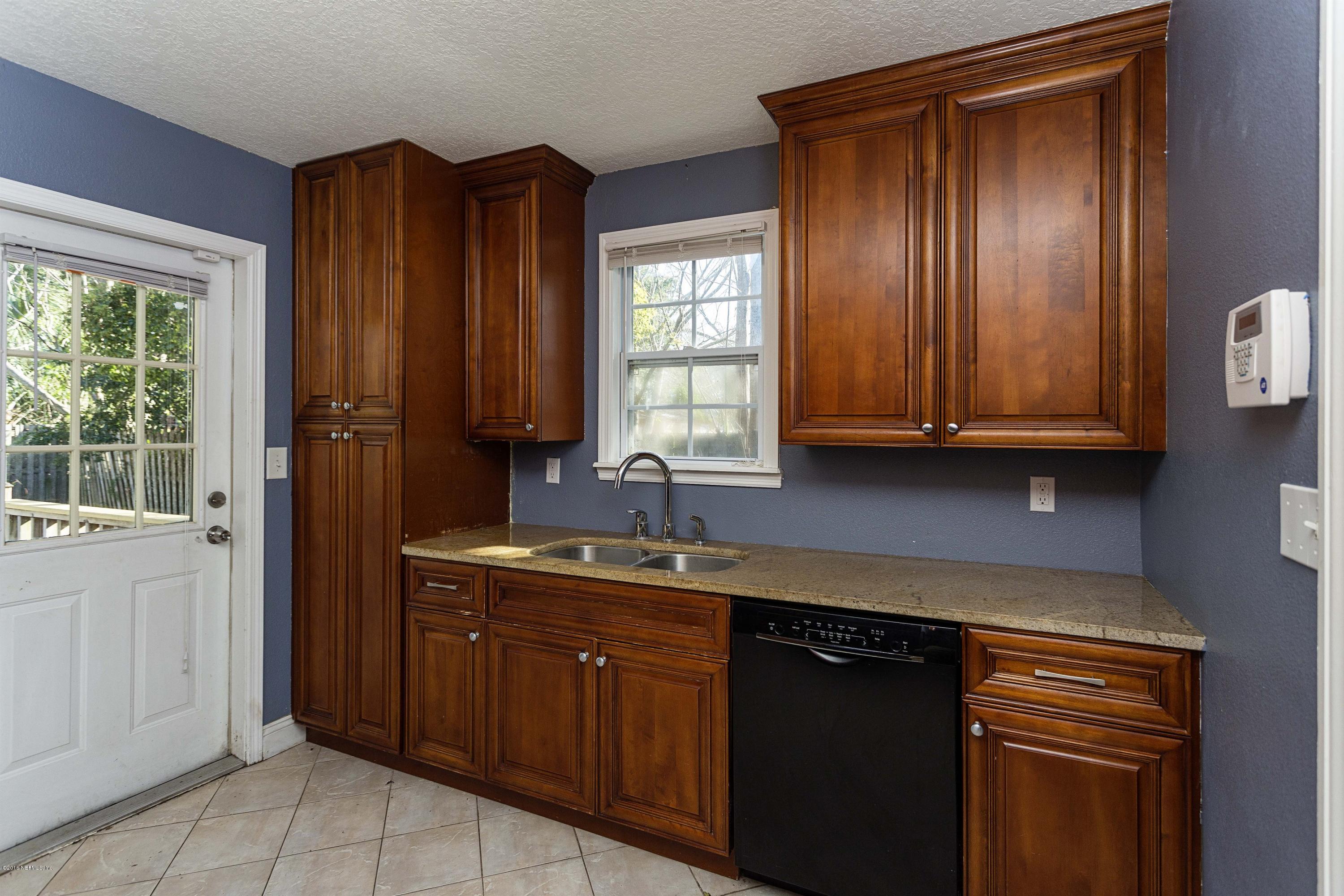 2309 Somerset Road Jacksonville, FL 32210 - Photo 9 of 21 a kitchen with stainless steel appliances granite countertop cabinets and window