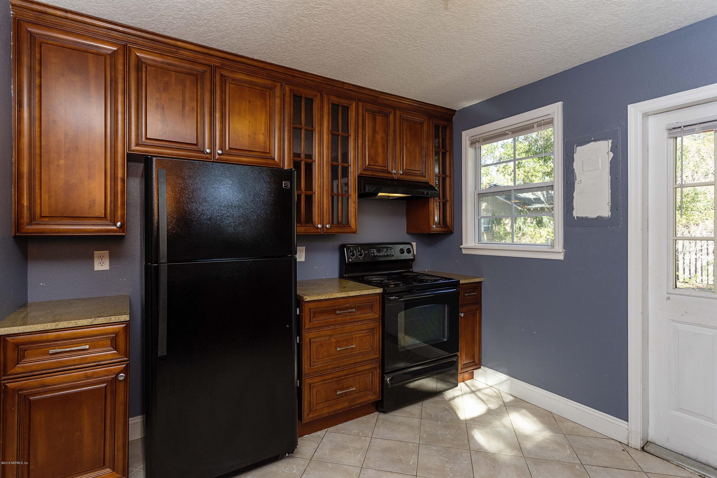 2309 Somerset Road Jacksonville, FL 32210 - Photo 10 of 21 a kitchen with granite countertop stainless steel appliances a refrigerator stove and microwave
