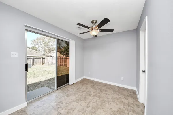 a view of an empty room and window and wooden floor
