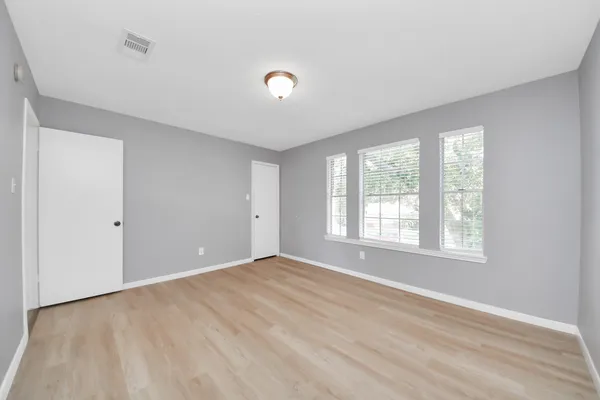 a view of an empty room and wooden floor
