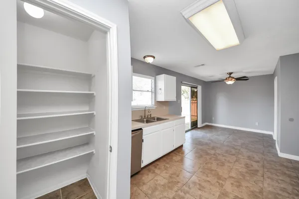 a view of a kitchen with a sink and a window