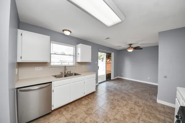 a kitchen with cabinets and stainless steel appliances