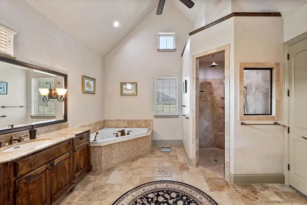 a bathroom with a tub sink and shower