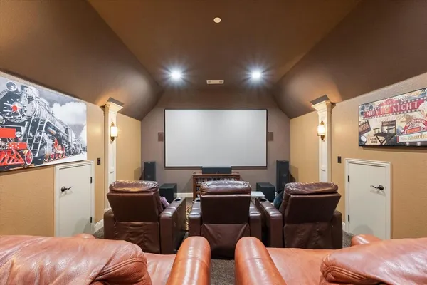 a room with furniture pool table and wall paintings