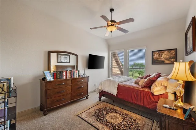 a bedroom with furniture and a flat screen tv
