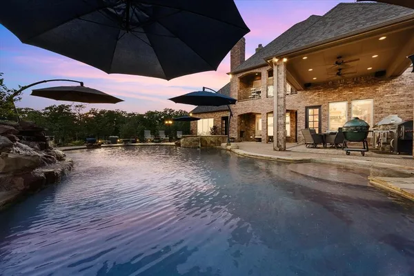a view of a patio with a table under an umbrella