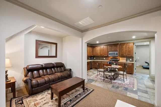 a living room with furniture and view of kitchen