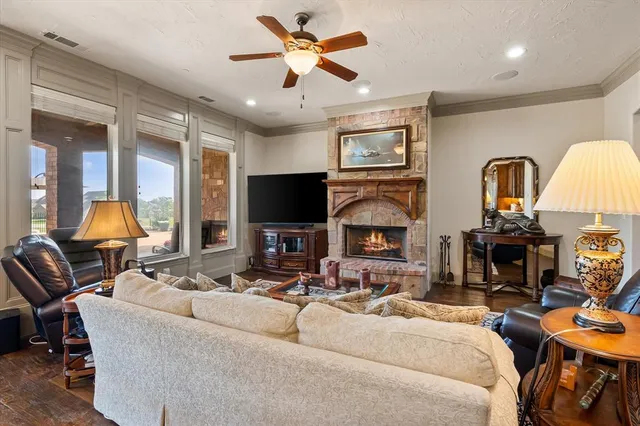 a living room with furniture a fireplace and a flat screen tv