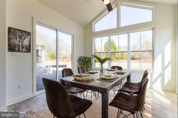 a view of a dining room with furniture large window and outside view