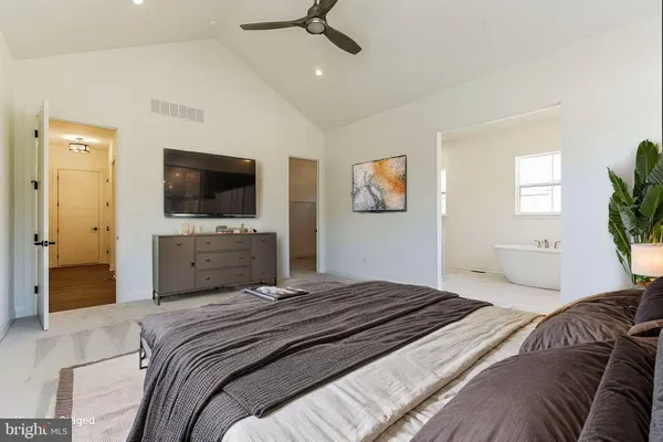 a bedroom with a bed and a flat screen tv