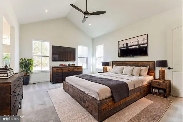 a bedroom with a bed and a flat screen tv