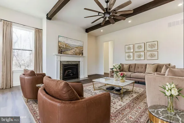 a living room with furniture a fireplace and a large window