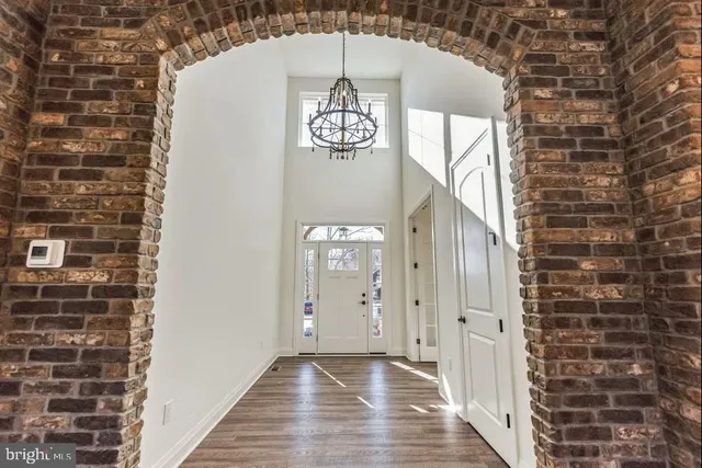 a view of a hallway with wooden door