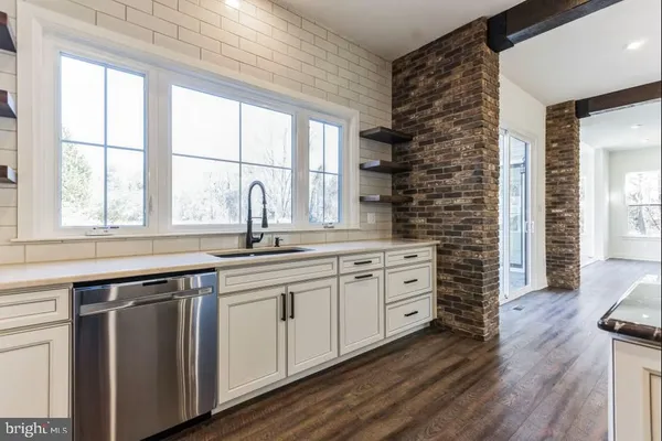 a view of cabinets a wooden floor and a window