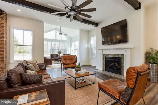 a living room with furniture fireplace and flat screen tv