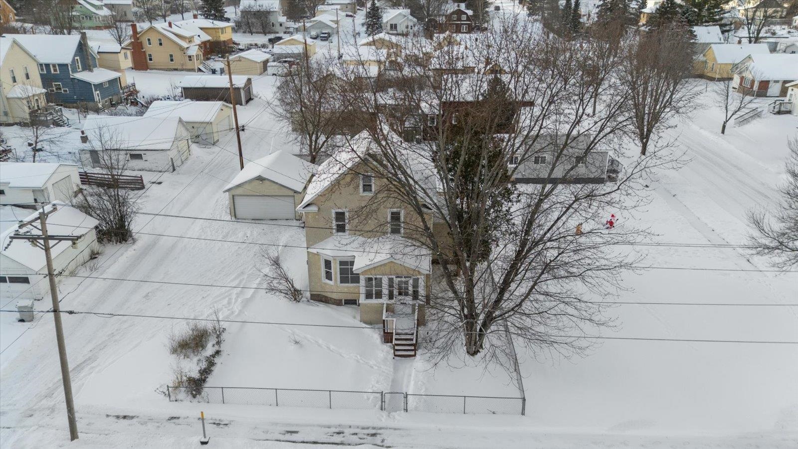 Snowy aerial view featuring a residential view