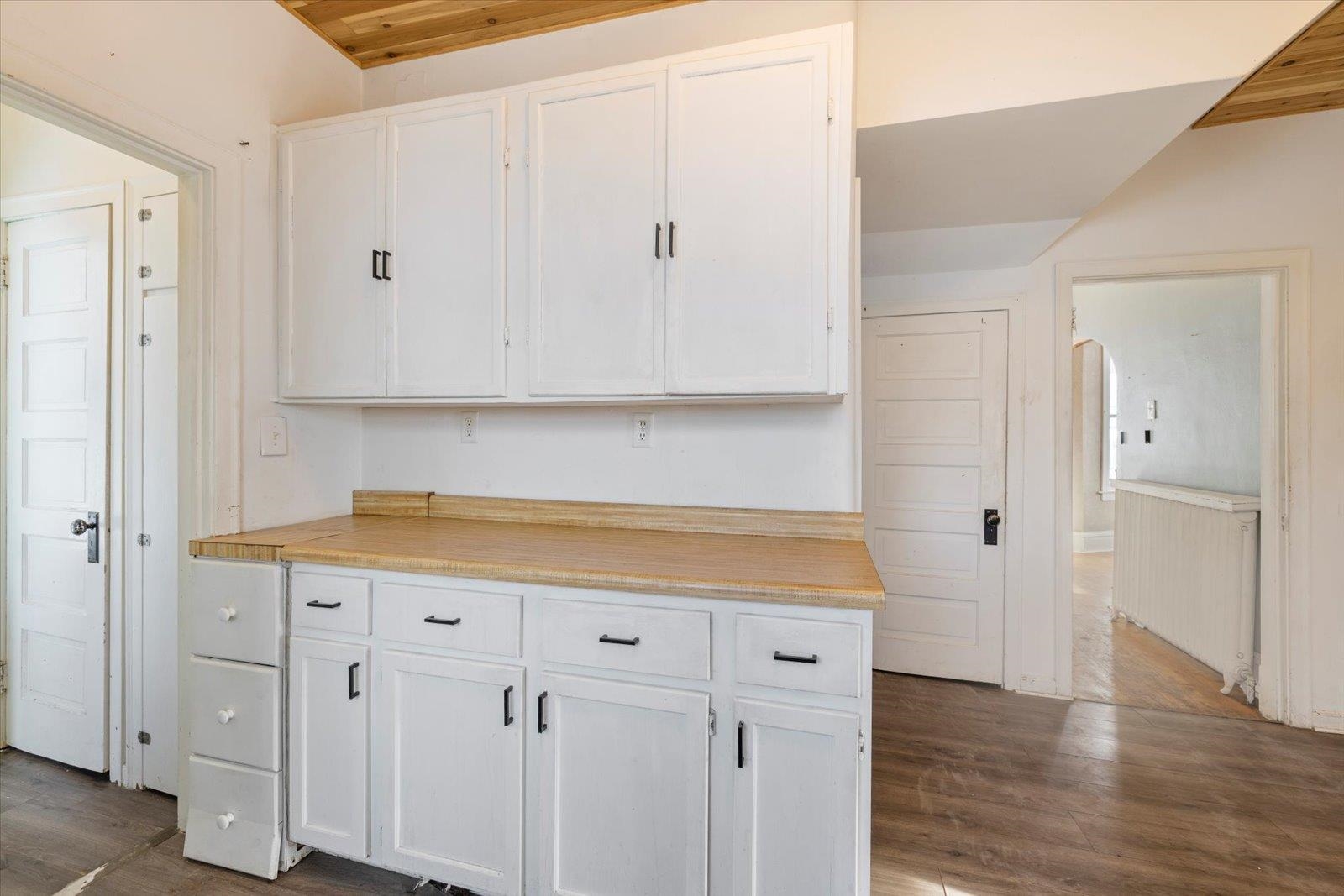 217 3rd Avenue Northwest Chisholm, MN 55719 - Photo 11 of 47 Kitchen with white cabinets, light countertops, and arched walkways