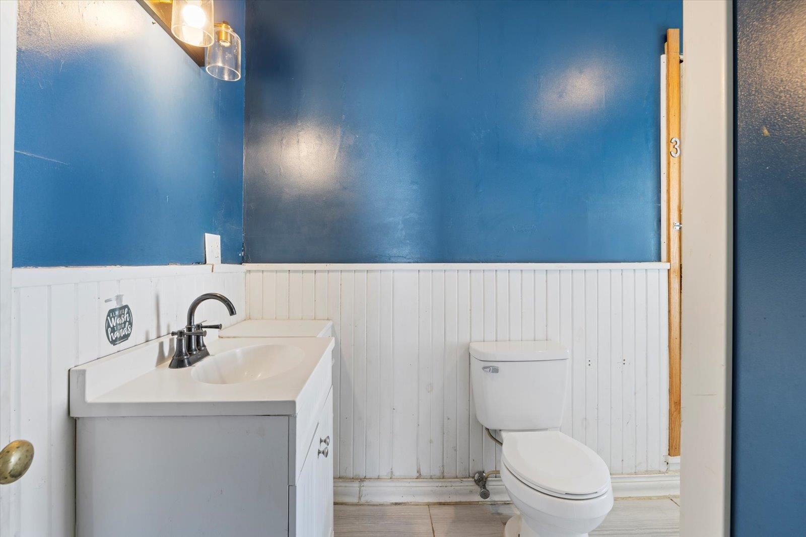 217 3rd Avenue Northwest Chisholm, MN 55719 - Photo 19 of 47 Bathroom with vanity and wainscoting