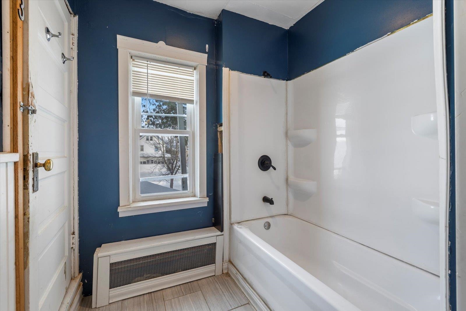 217 3rd Avenue Northwest Chisholm, MN 55719 - Photo 20 of 47 Bathroom featuring radiator and bathtub / shower combination