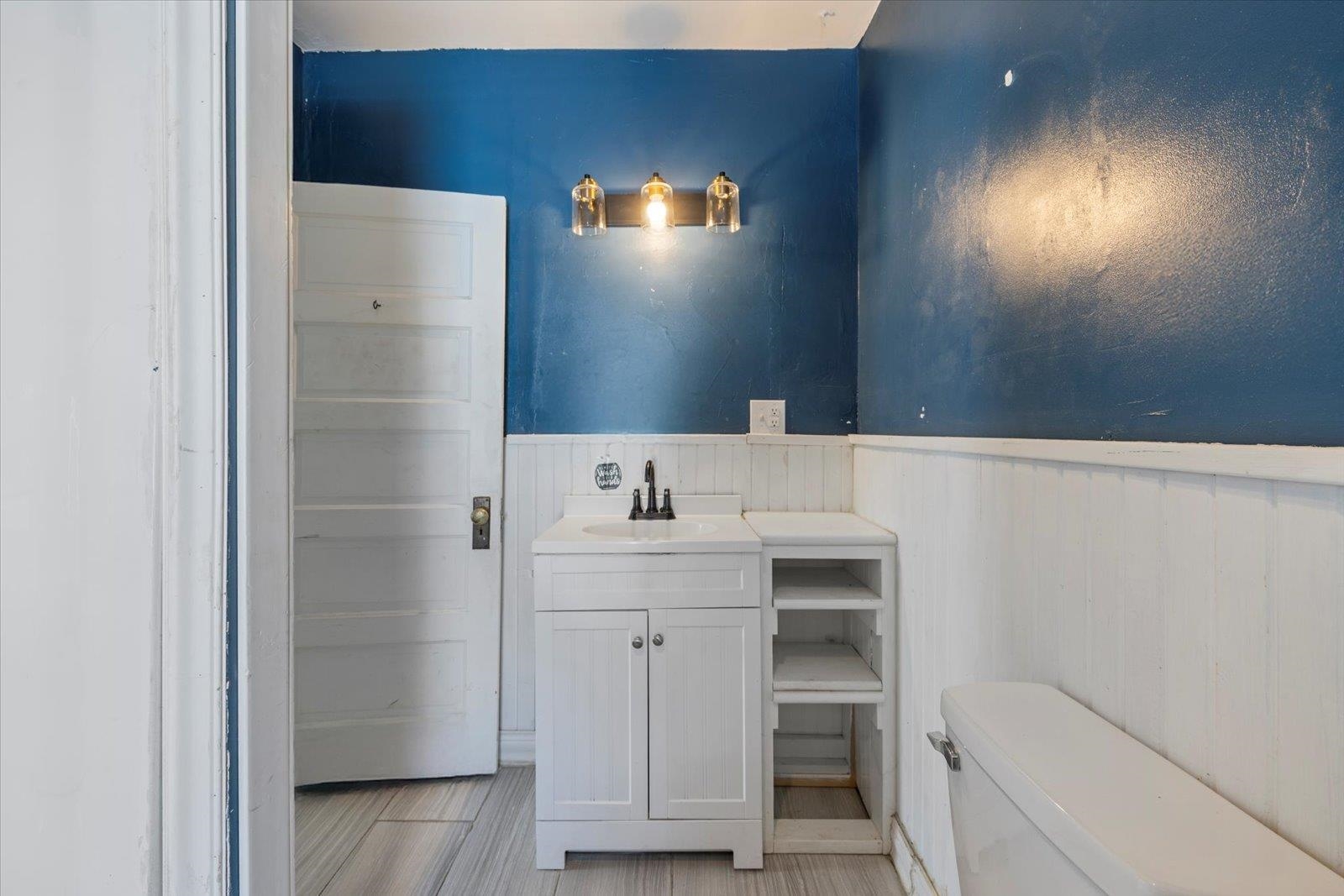 217 3rd Avenue Northwest Chisholm, MN 55719 - Photo 21 of 47 Bathroom featuring vanity and a wainscoted wall