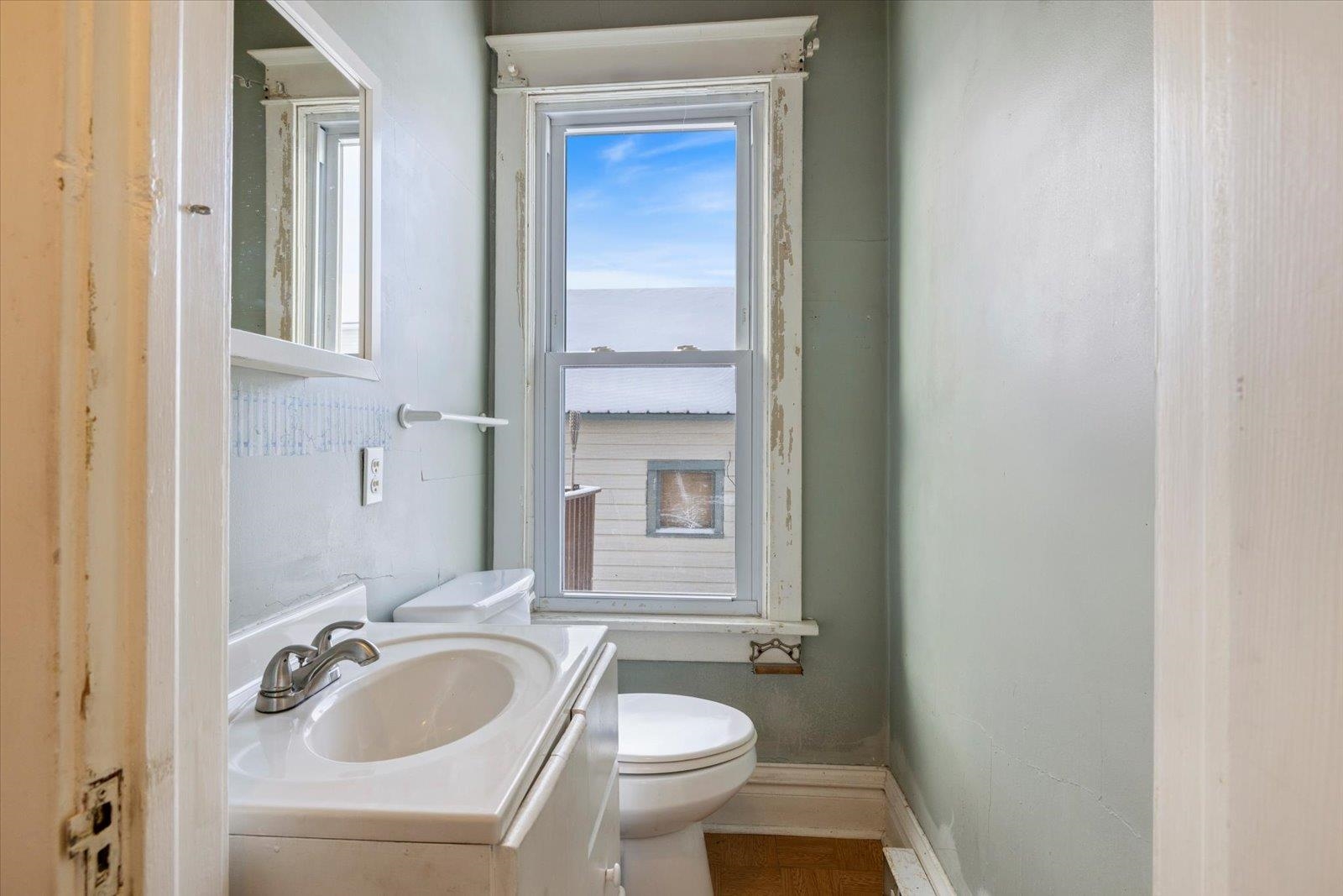 217 3rd Avenue Northwest Chisholm, MN 55719 - Photo 22 of 47 Half bath with vanity and toilet