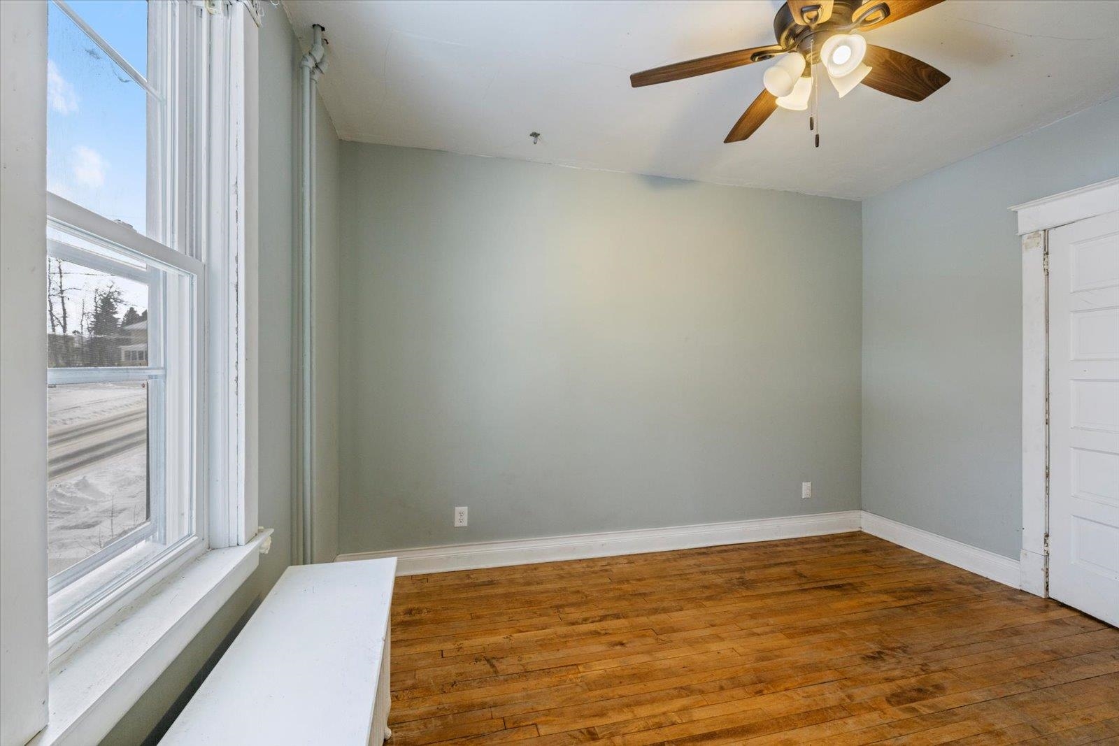 217 3rd Avenue Northwest Chisholm, MN 55719 - Photo 24 of 47 Spare room featuring wood-type flooring, healthy amount of natural light, and a ceiling fan