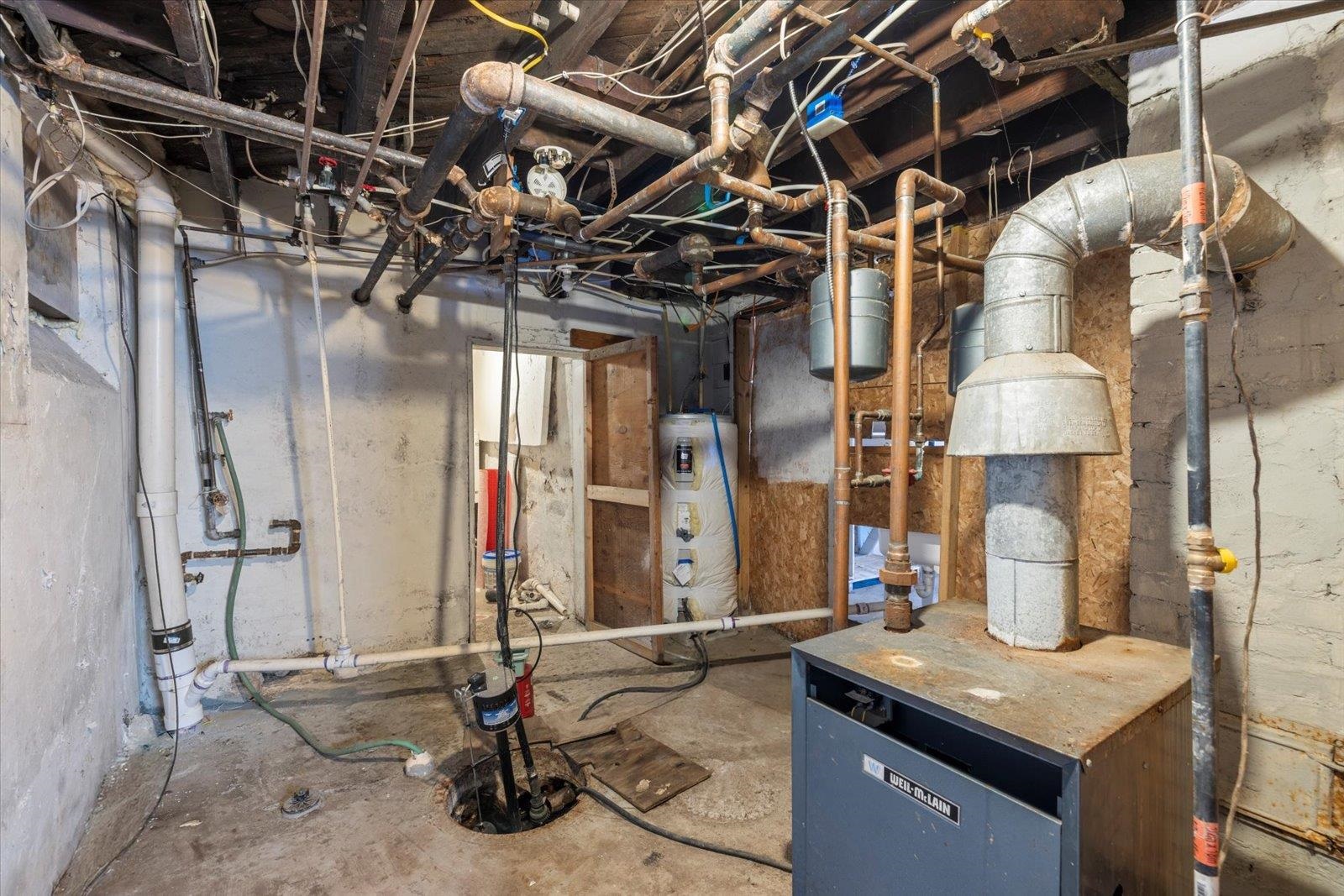 217 3rd Avenue Northwest Chisholm, MN 55719 - Photo 38 of 47 Unfinished basement with a heating unit and water heater