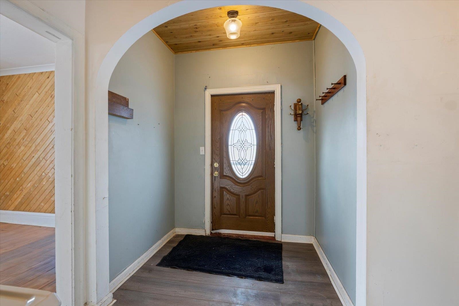 217 3rd Avenue Northwest Chisholm, MN 55719 - Photo 40 of 47 Foyer featuring arched walkways, wood finished floors, and wood ceiling