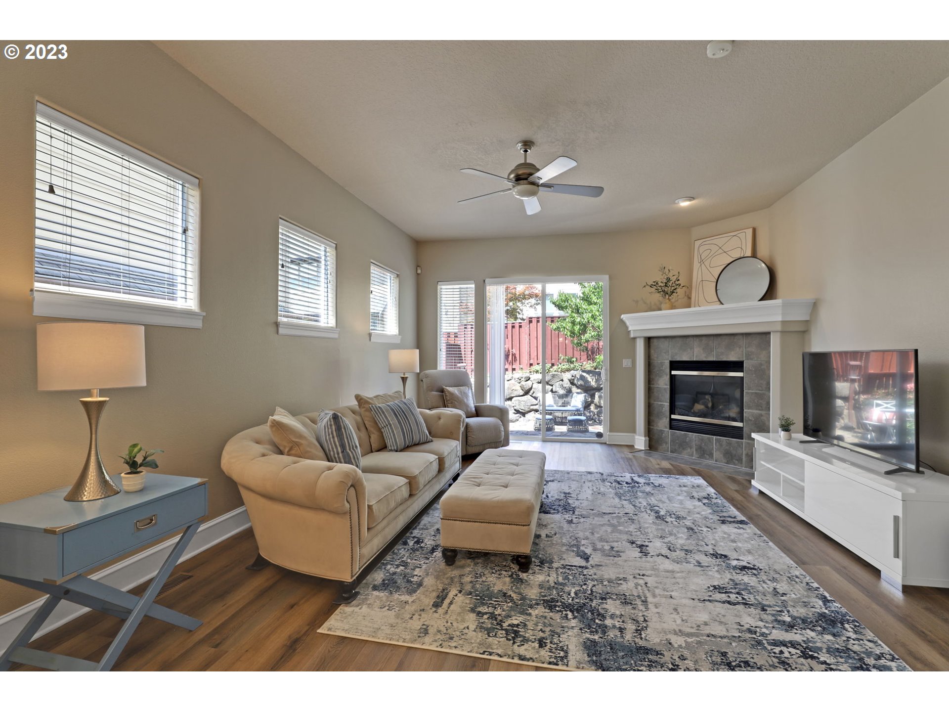 12799 Northwest Forest Spring Lane Portland, OR 97229 - Photo 13 of 30 a living room with furniture a fireplace and a flat screen tv