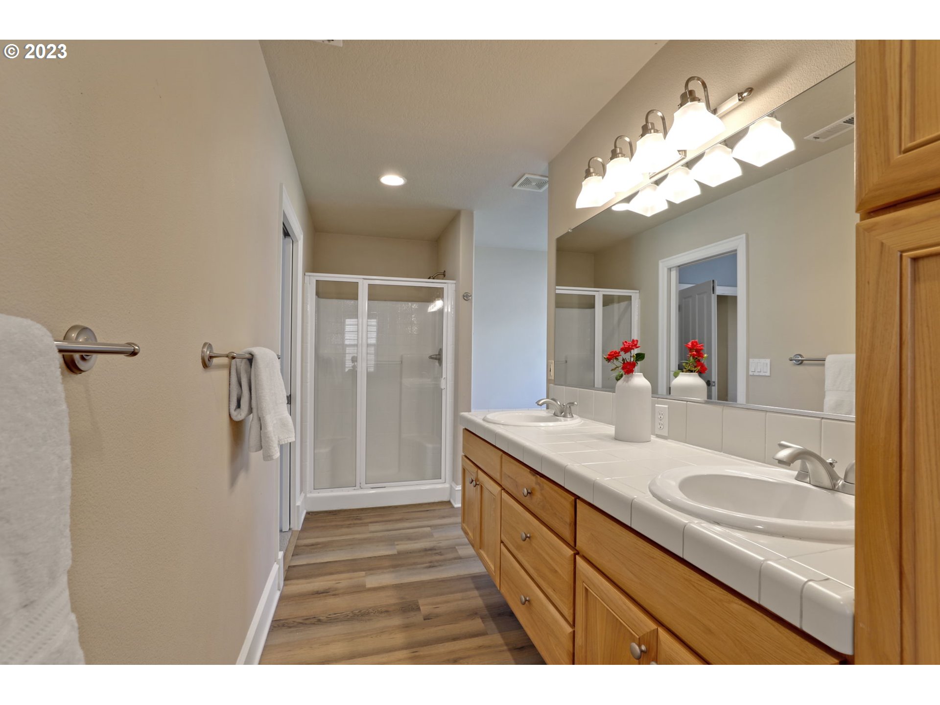12799 Northwest Forest Spring Lane Portland, OR 97229 - Photo 16 of 30 a bathroom with a sink mirror and a shower