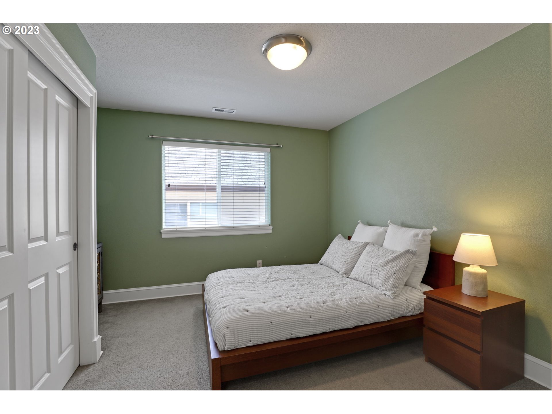 12799 Northwest Forest Spring Lane Portland, OR 97229 - Photo 21 of 30 a bedroom with a bed and window