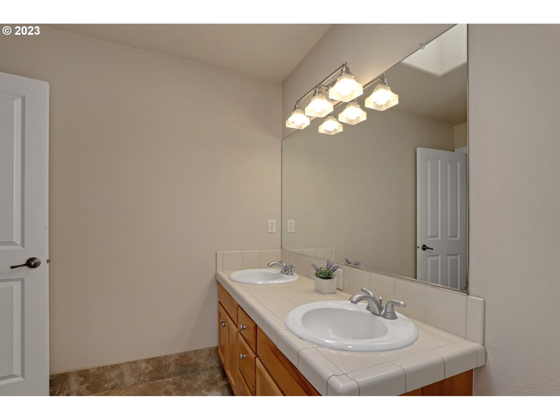 12799 Northwest Forest Spring Lane Portland, OR 97229 - Photo 23 of 30 a bathroom with a sink and a mirror