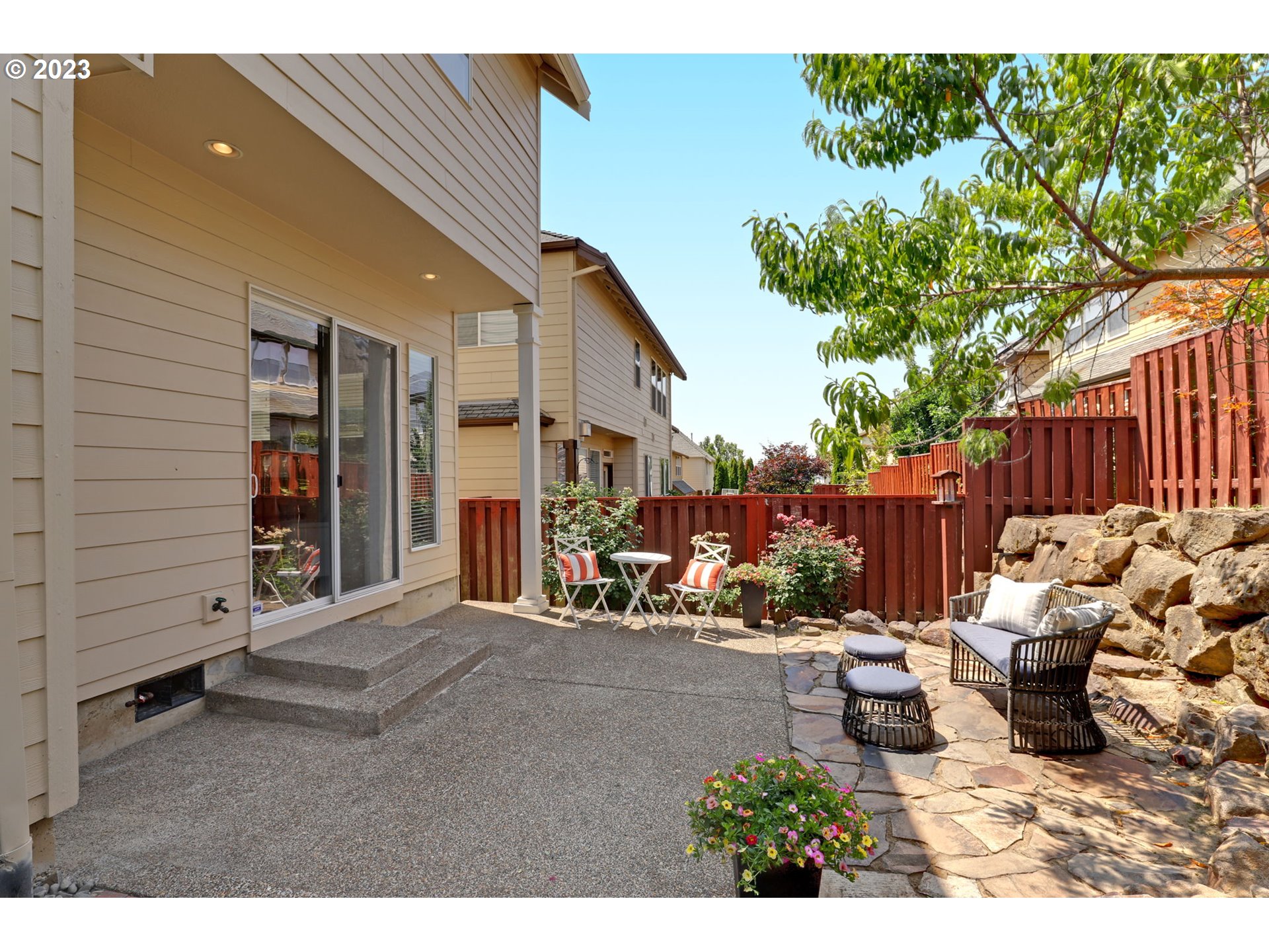 12799 Northwest Forest Spring Lane Portland, OR 97229 - Photo 26 of 30 a view of a patio with table and chairs and potted plants