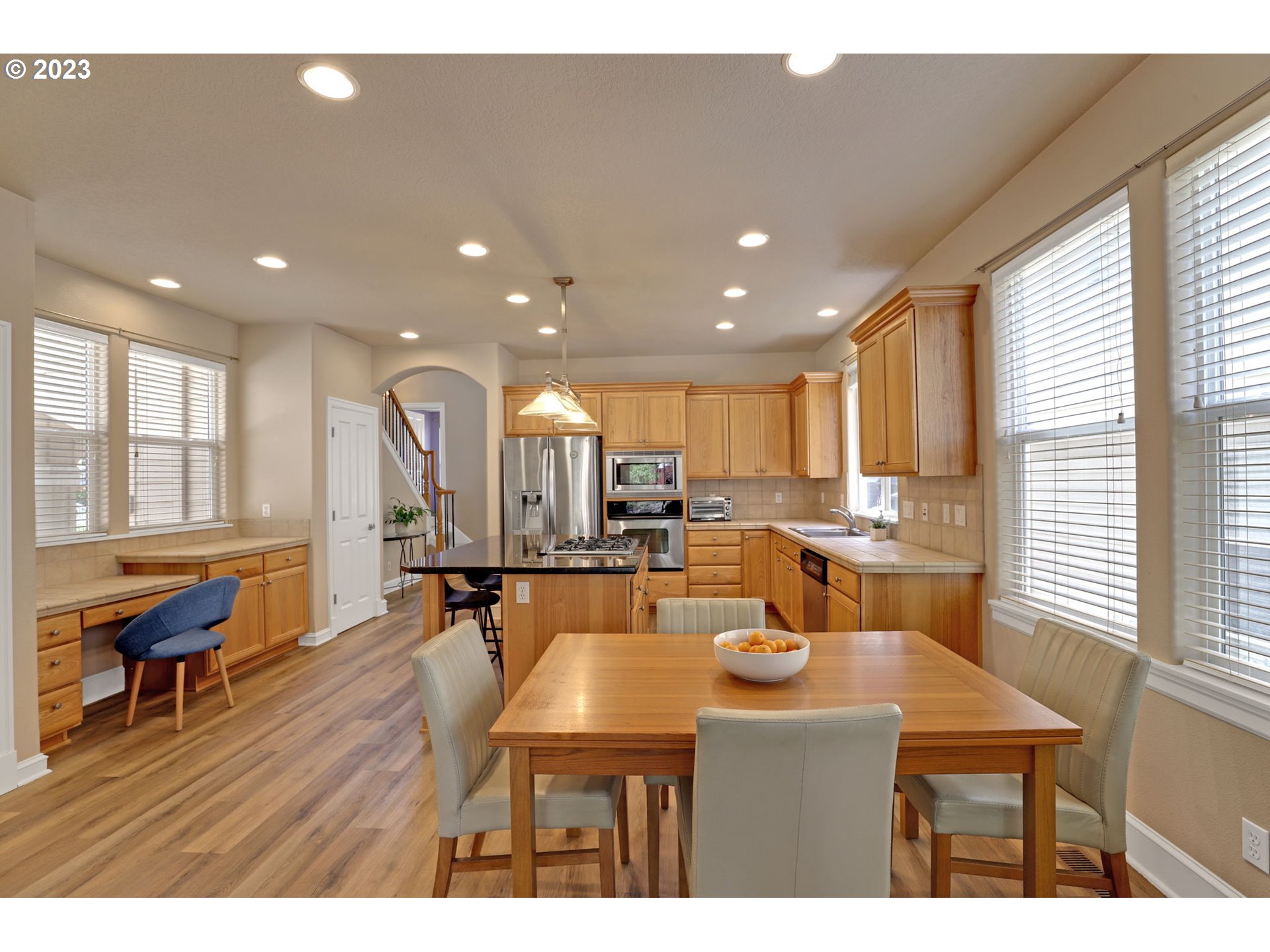 12799 Northwest Forest Spring Lane Portland, OR 97229 - Photo 9 of 30 a dining room with wooden floor and large windows