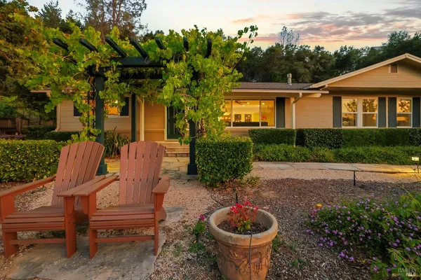 a view of a patio with table and chairs and a flower pot