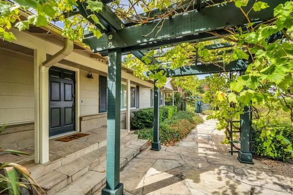 a kitchen with stainless steel appliances granite countertop a sink a stove and a refrigerator