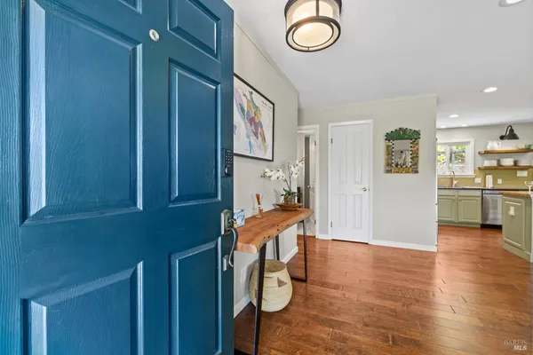 a view of a dining room with furniture and a potted plant