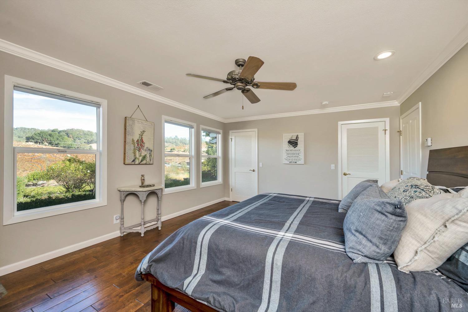 1389 Canyon Road Geyserville, CA 95441 - Photo 18 of 48 a spacious bedroom with a bed and wooden floor