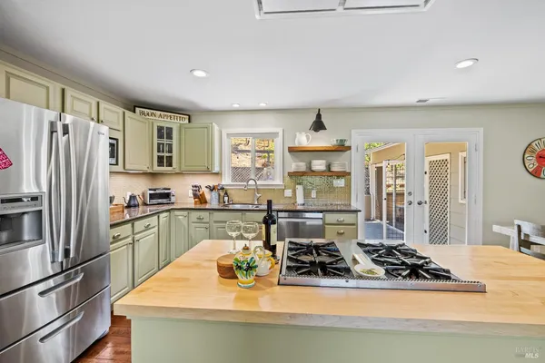 a spacious bedroom with a bed and wooden floor
