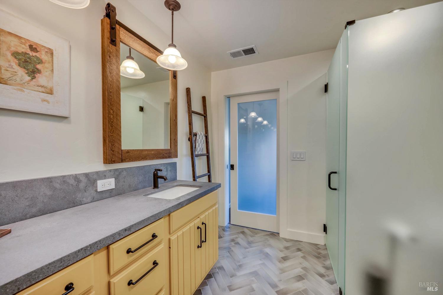 1389 Canyon Road Geyserville, CA 95441 - Photo 21 of 48 a bathroom with a granite countertop sink a mirror and a shower