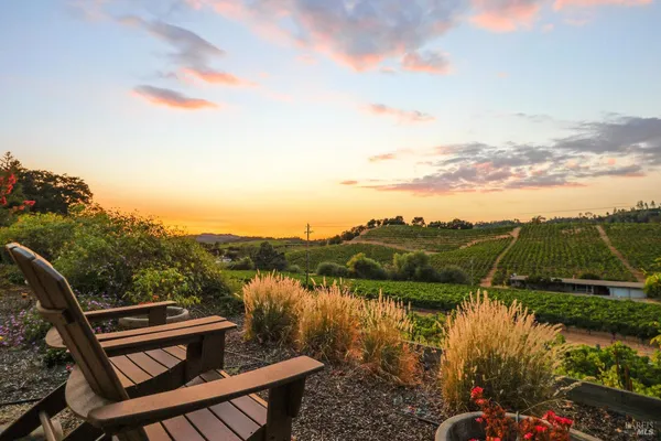 a aerial view of a house next to a yard
